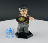 Custom figure holding a disc on a white platform with a dark background, featuring the Calypso Customs logo.